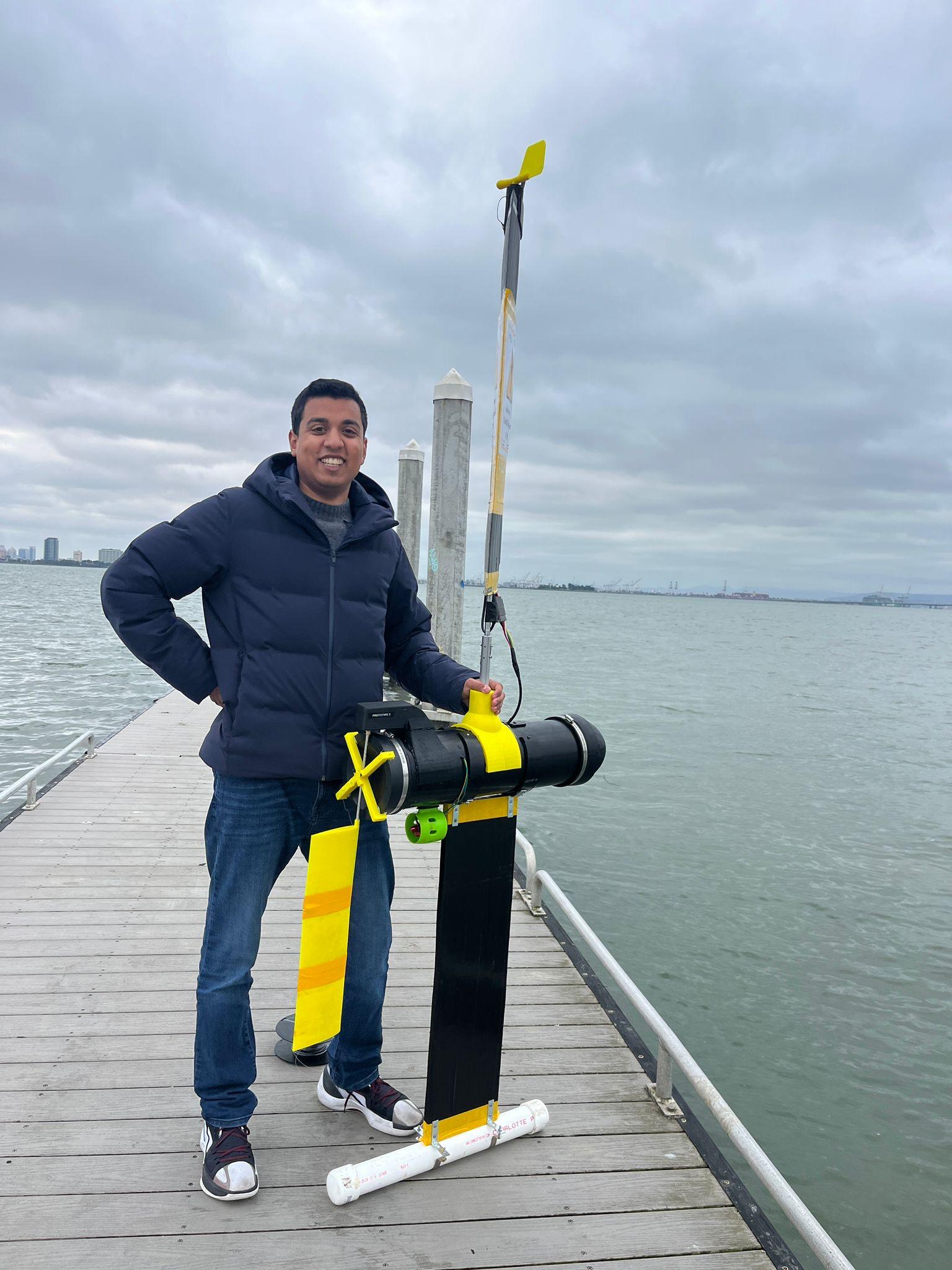 Kieran on the Berkeley Marina pier with an autonomous sail drone
